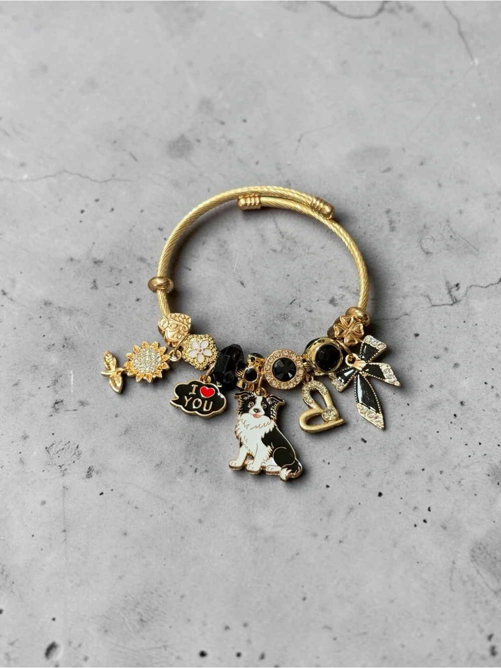 Gold Tone Charm Adjustable Twisted Bangle W/Black & White Dog and Heart Charms